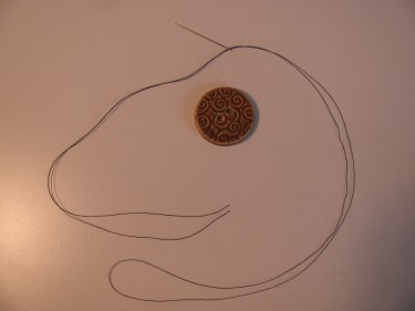 a button and thread on a needle, thread shank post, 090