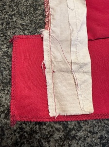 9640, other side seam sewn, red thread not cut yet, how to fix a ripped hem